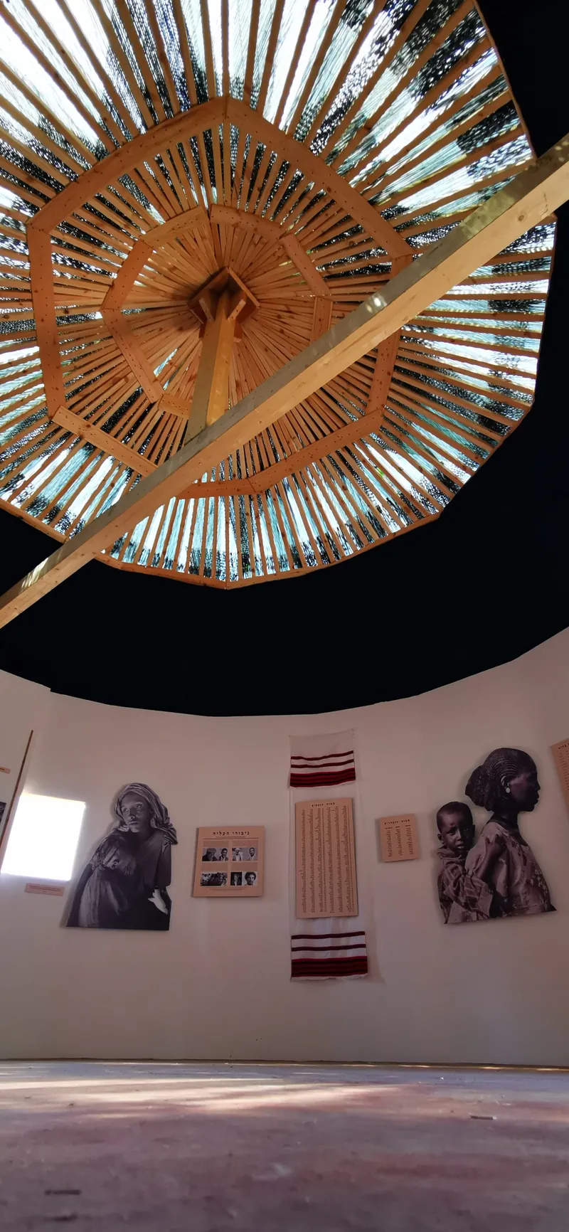 Woven-domed heritage room with a hanging timeline of the Ethiopian Jewish journey