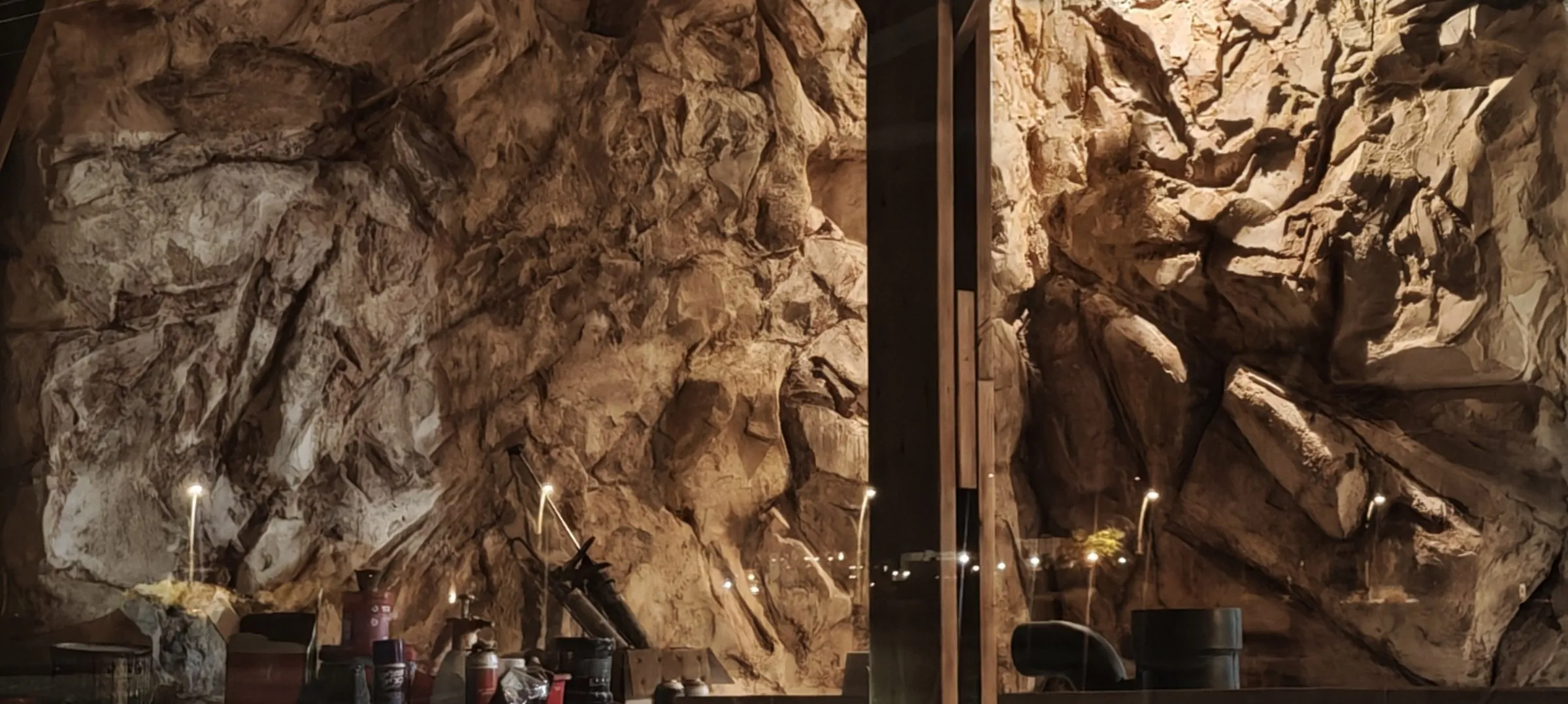 Hand-carved stone walls of a luxury desert restaurant interior built by Shidrah Studio in the Negev